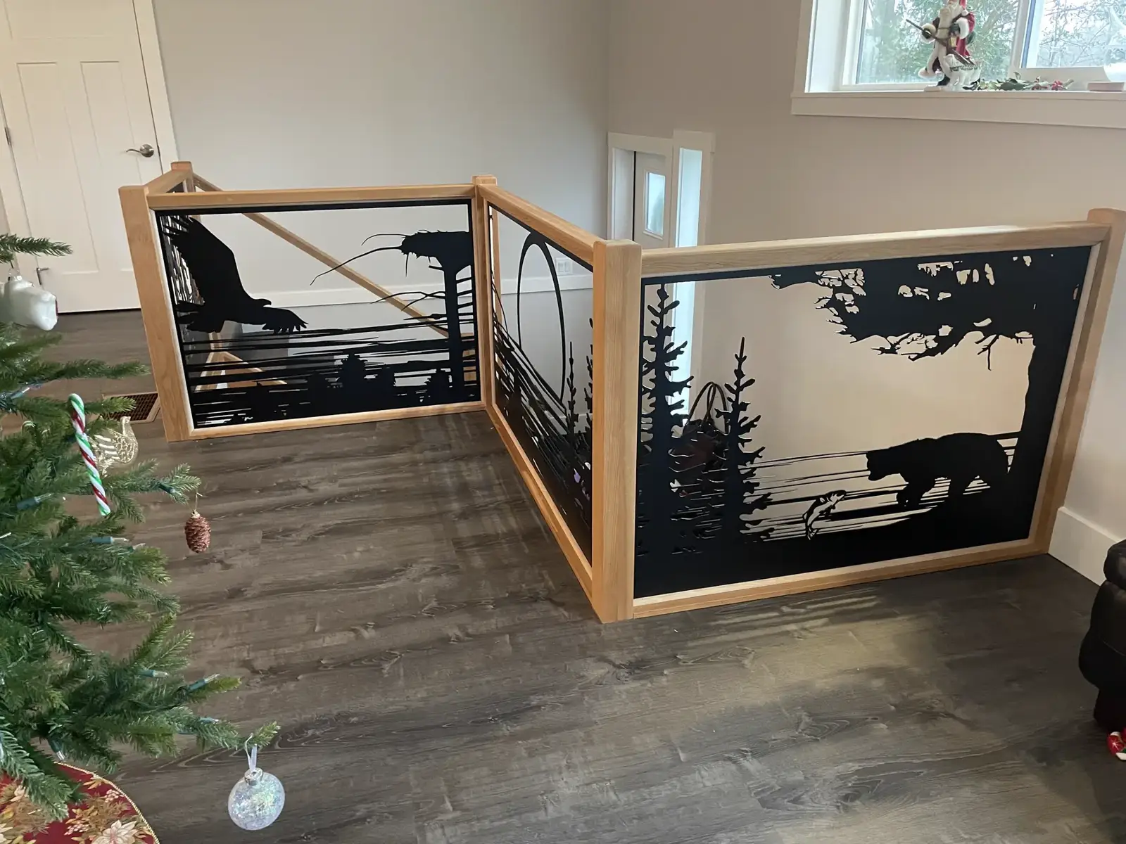 Loft railing with forest and wildlife panels in wood frames