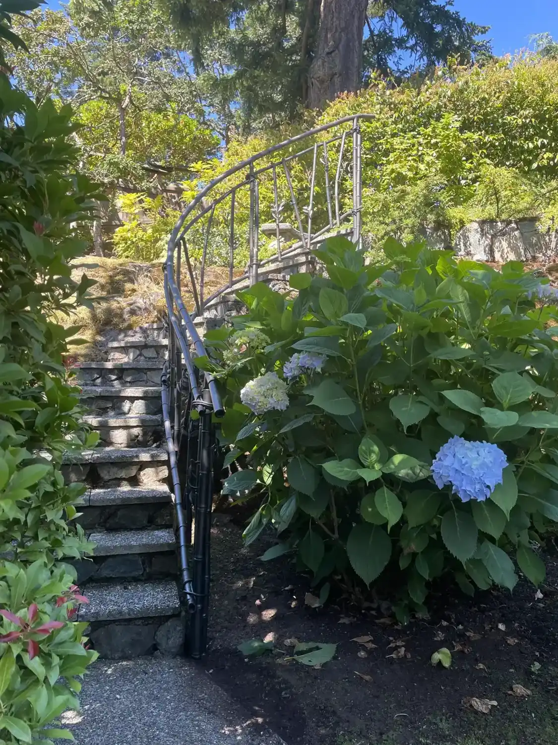 Steel handrail shaped like bamboo running up a garden stair